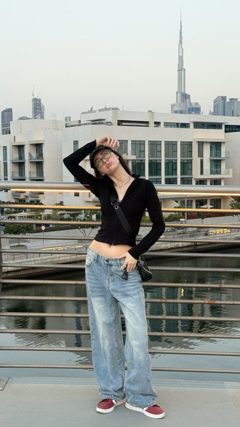 Alina on a balcony with the Dubai skyline