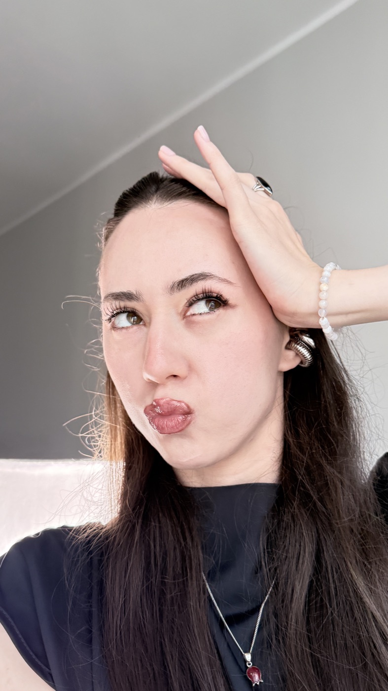 Alina Say with her hand in her hair, looking to the side